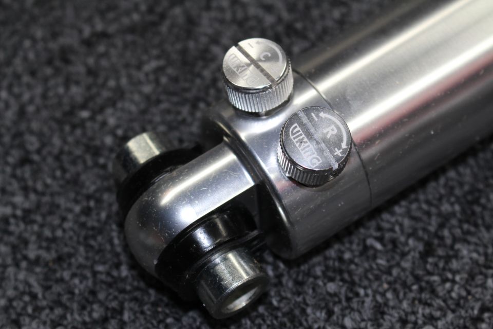 Close-up of a Viking shock absorber's dual adjustment knobs marked R and L on the polished body