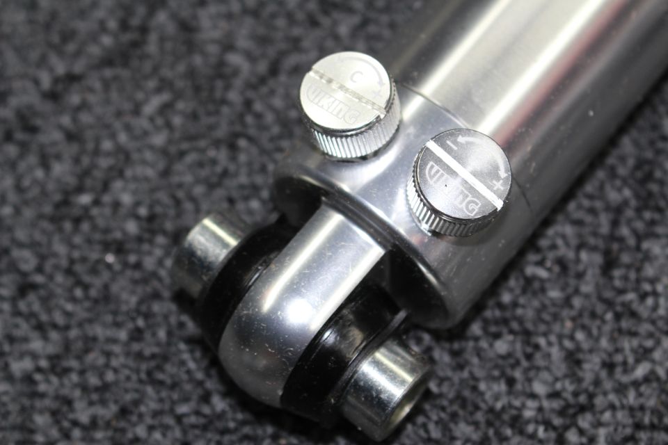 Polished coilover shock body with two knurled Viking adjuster knobs and lower clevis mount