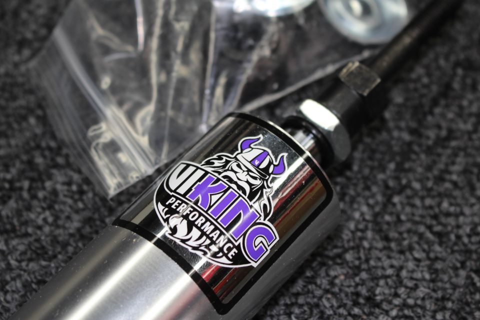 Coilover shock end with purple-and-black Viking Performance viking-head logo sticker