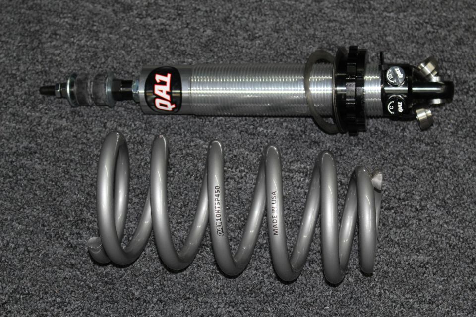 QA1 coilover shock above a gray coil spring marked QA110HTSF450 Made in USA