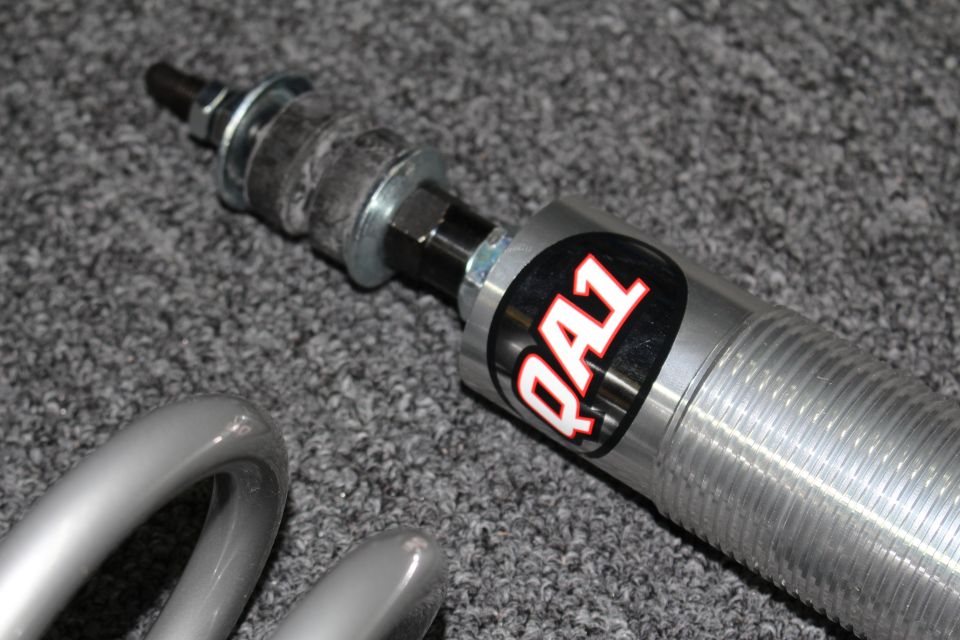 Threaded coilover shaft and body with red-and-black QA1 logo decal