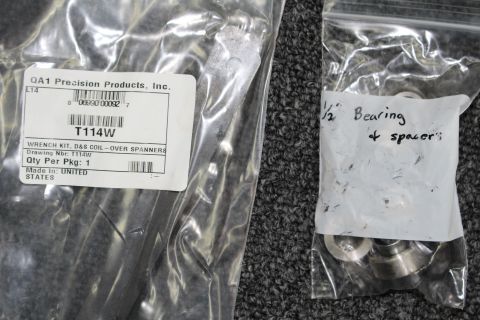2003 Ford Crown Victoria - QA1 coil-over spanner wrench kit in its labeled bag next to a smaller bag handwritten with bearing and spacer notes.