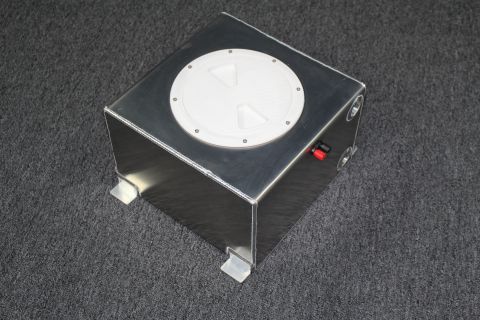 2003 Ford Crown Victoria - brushed aluminum fuel cell with a white twist-lock cap on top and barbed outlet fittings on its side, on gray carpet.