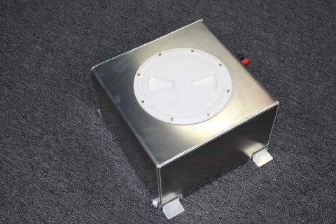2003 Ford Crown Victoria - welded brushed-aluminum fuel cell with a white round access cap and mounting tabs photographed on gray carpet.