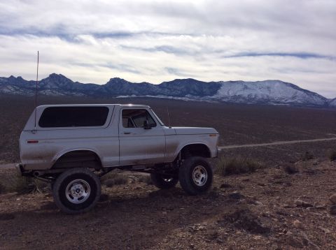 1979 Ford Bronco - This lifted 1978 Ford Bronco is parked on a dirt road with mountains in the distance.