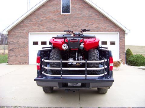 1984 Honda ATC 250 R - A red ATV is loaded into the bed of a dark blue pickup truck, viewed from the rear.
