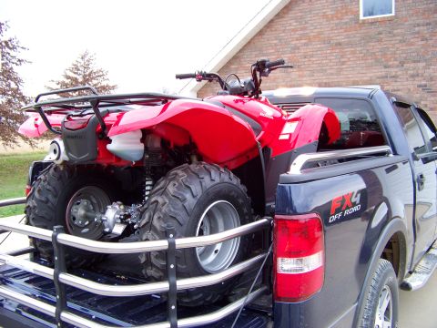 1984 Honda ATC 250 R - Red ATV loaded in the bed of a dark blue Ford F-150 pickup truck.
