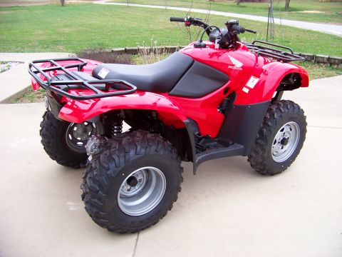 1984 Honda ATC 250 R - A red ATV is parked outdoors on a paved surface.
