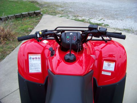 1984 Honda ATC 250 R - Close-up view of the front of a red ATV, showing the handlebars, controls, and part of the seat.