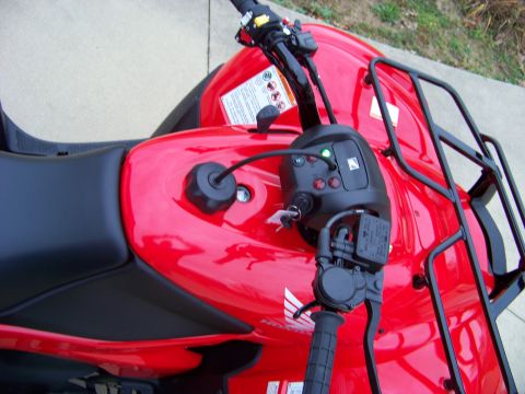 1984 Honda ATC 250 R - Detail shot of a red ATV, focusing on the controls and seating area. Includes a visible watermark.