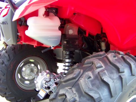 1984 Honda ATC 250 R - Close-up view of the rear mechanical components and red bodywork of an all-terrain vehicle.