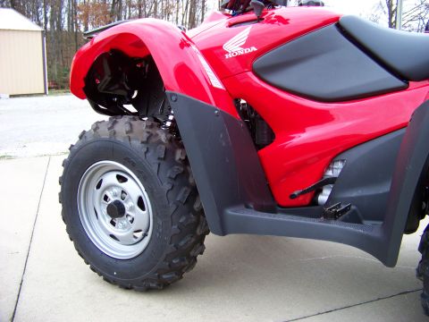 1984 Honda ATC 250 R - A red ATV is shown from the side, with a focus on its front wheel and fender assembly.