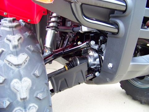 1984 Honda ATC 250 R - ATV front suspension and tire detail, showing the drive shaft and shock absorber.