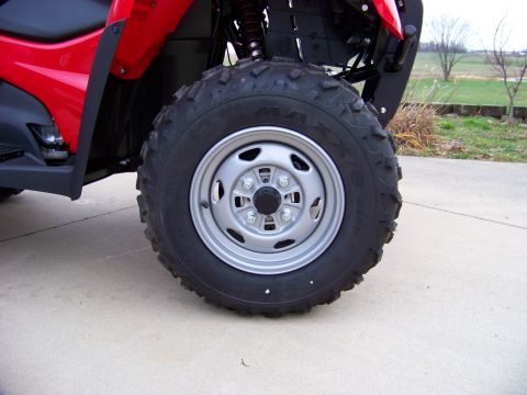 1984 Honda ATC 250 R - A red ATV sits on a concrete surface with a grassy field in the background.