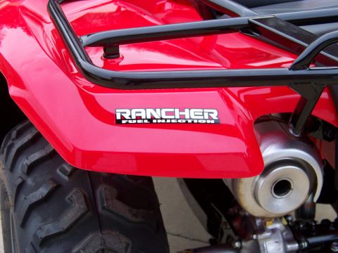 1984 Honda ATC 250 R - Close-up of a red ATV's rear fender, showing the 'Rancher Fuel Injection' badge.