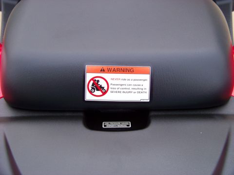 1984 Honda ATC 250 R - A warning label is affixed to the seat of an all-terrain vehicle.