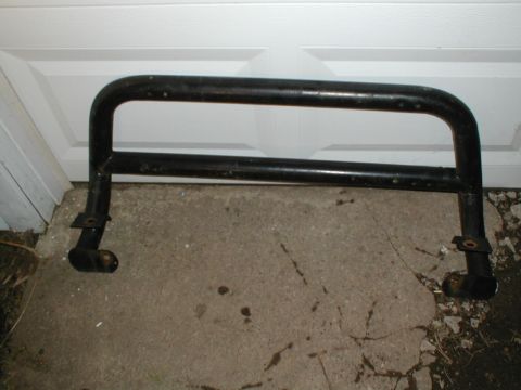 1979 Ford Bronco II - A black metal brush guard is shown resting on a concrete surface in front of a white garage door.