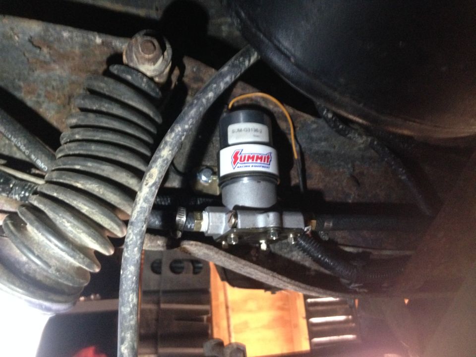 Summit Racing Equipment fuel pump mounted on vehicle frame near a coil spring