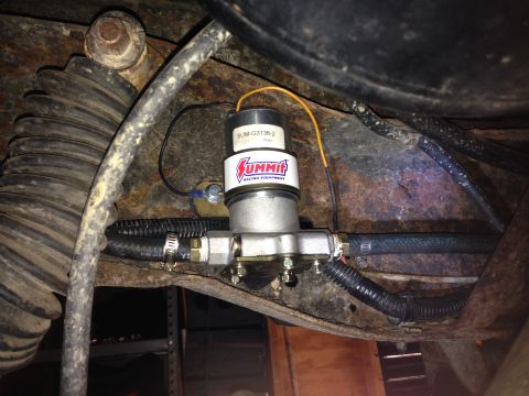 1979 Ford Bronco - An aftermarket Summit Racing Equipment electric fuel pump is installed on a vehicle's undercarriage, showing hoses and wiring.