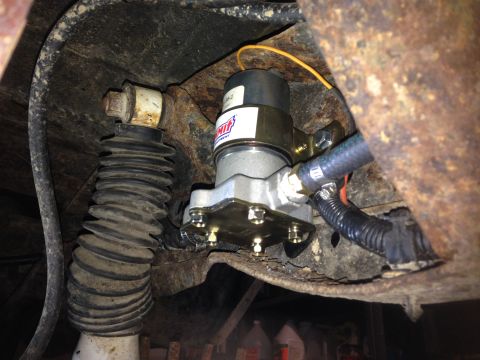 1979 Ford Bronco - A close-up view of a fuel pump assembly attached to a vehicle's chassis.
