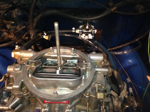 1979 Ford Bronco - This photo shows a carburetor with associated fuel lines and a central rod, not a 1979 Ford Bronco.