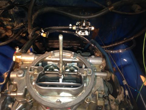 1979 Ford Bronco - Close-up of a carburetor and fuel pump assembly in an engine bay, with Supermotors branding visible.