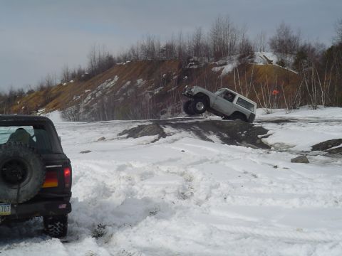 1993 Ford Bronco - A 1993 Ford Bronco navigates a snowy off-road course, demonstrating its capabilities in challenging terrain.
