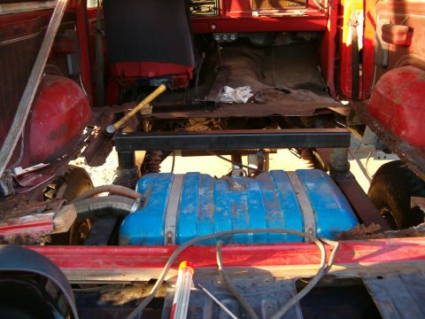 1979 Ford Bronco - Auxiliary fuel tank installed in the interior of a red vehicle.