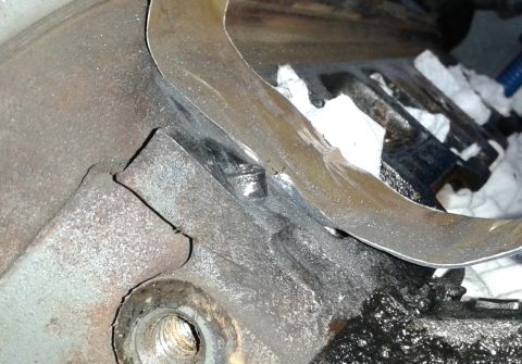 1996 Ford Bronco - Engine block detail showing a metal gasket and surrounding components.