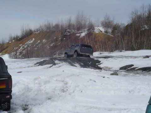 1993 Ford Bronco - Vehicles navigate a challenging off-road course covered in snow and ice.