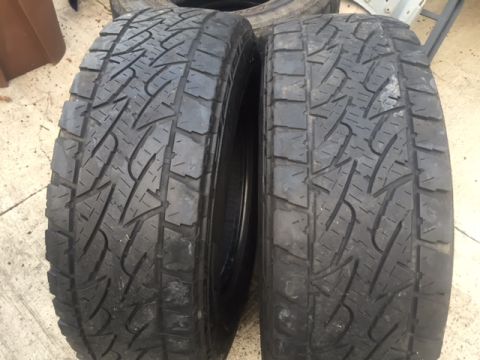1986 Ford Bronco - A close-up view of two Bridgestone Dueler tires, showing their tread pattern.