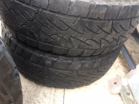 1986 Ford Bronco - A close-up view of stacked tires, showing their tread detail and sidewall construction.