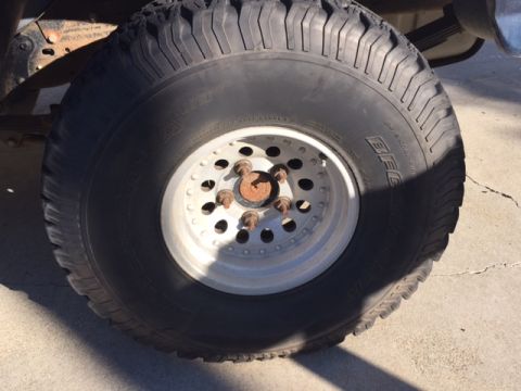 1986 Ford Bronco - A close-up view of a BFGoodrich tire and wheel assembly, showing the tread pattern and rim details.