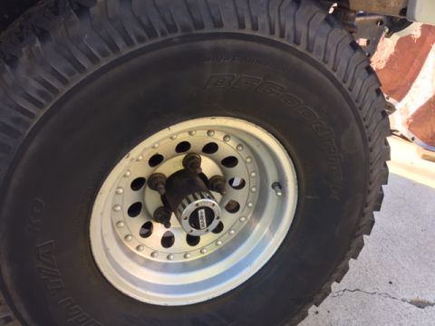 1986 Ford Bronco - A close-up view of a tire and wheel assembly, with visible text on the tire and a Supermotors.net watermark.