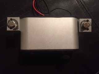 1986 Ford Bronco - A silver intercom unit with visible wiring and mounting hardware is shown against a dark background.