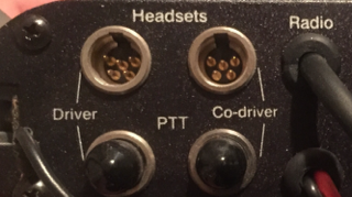 1986 Ford Bronco - Close-up of a RuggedRadio Intercom panel, showing connections for driver and co-driver headsets, PTT, and radio.