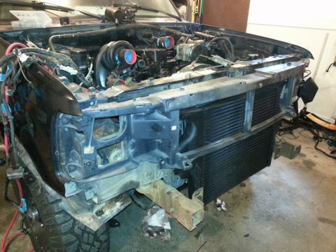 1994 Ford Bronco - Vehicle engine bay with twin turbochargers installed, undergoing modification or repair.