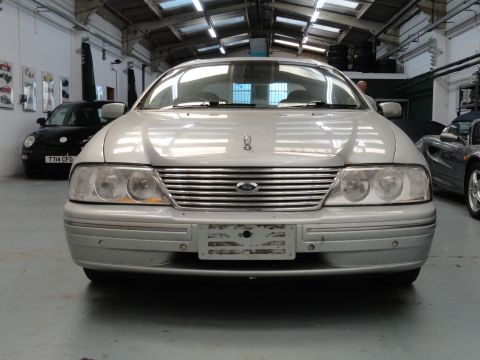 1999 Ford Fairlane - Front view of a silver sedan, possibly a Ford Fairlane, in a garage setting.