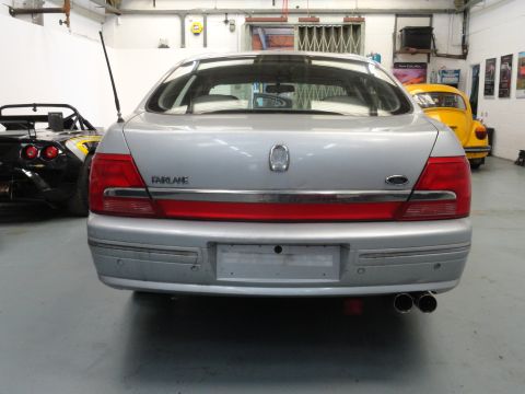 1999 Ford Fairlane - Rear view of a silver 1999 Ford Fairlane sedan, showing its taillights and 'FAIRLANE' badging.