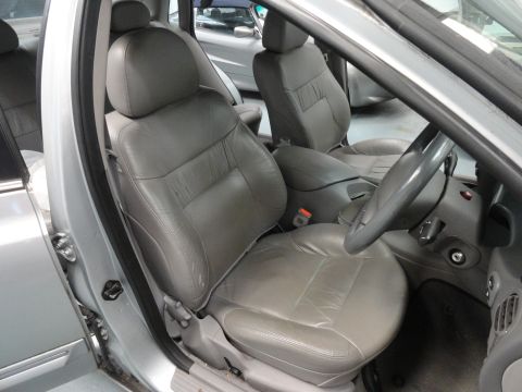 1999 Ford Fairlane - Interior view of a car, showing the front seats and dashboard. The registry claims it is a 1999 Ford Fairlane, but this cannot be confirmed…