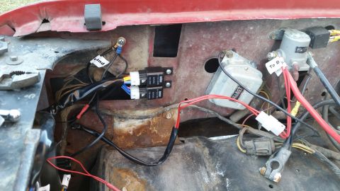 1981 Ford Bronco - This image shows a close-up view of wiring and electrical components, likely in the engine bay of a vehicle. Two black automotive relays ar…
