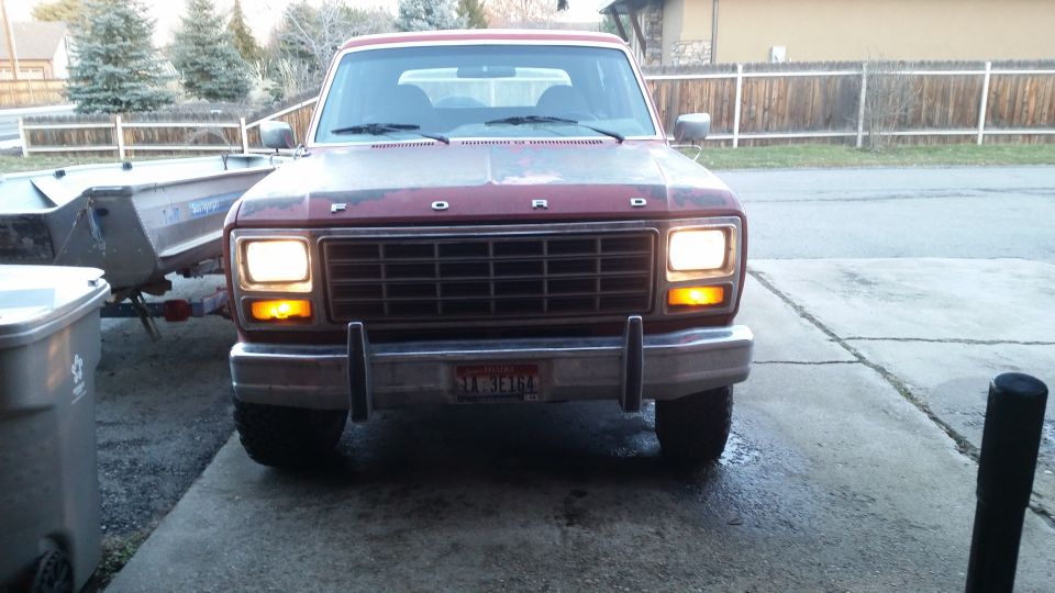 1981 Ford Bronco front view, red, headlights on