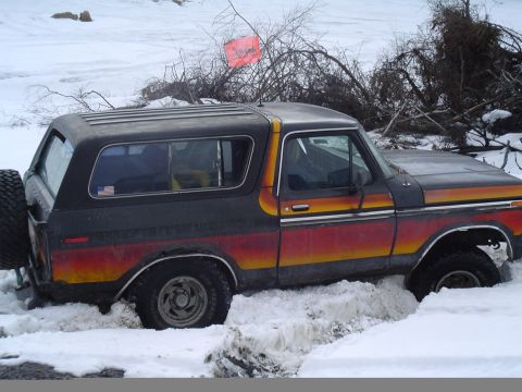 1993 Ford Bronco - This Ford Bronco is stuck in a snowy area, with its rear tire visible.