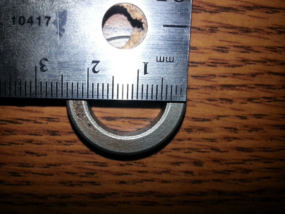 Metal ruler measuring a metal ring.