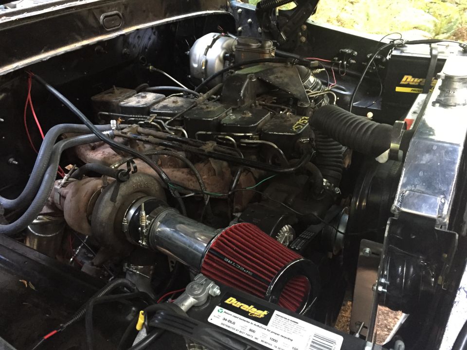 Modified diesel engine with turbocharger and red air filter.