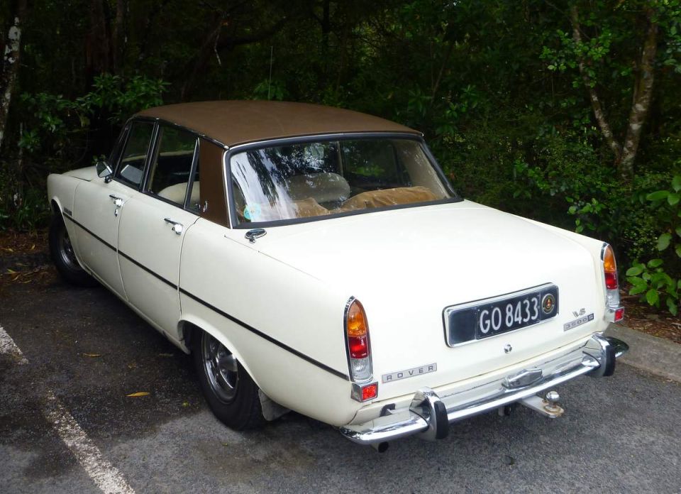 White 1969 Rover sedan, rear passenger side view, parked outdoors.