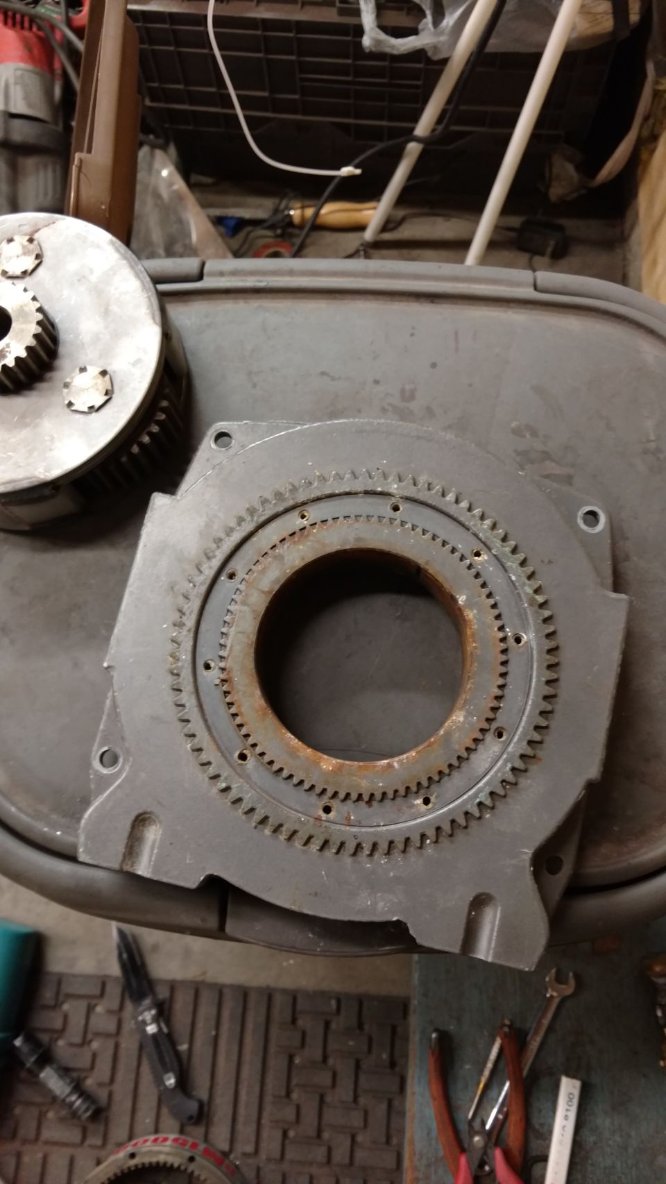 Close-up of a rusty gear assembly with a smaller gear component.