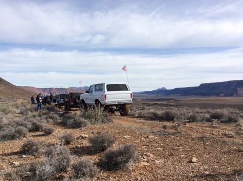 1979 Ford Bronco - A white 1979 Ford Bronco, nicknamed "Pearl", is parked in a desert landscape with a line of other off-road vehicles behind it. The Bronco h…