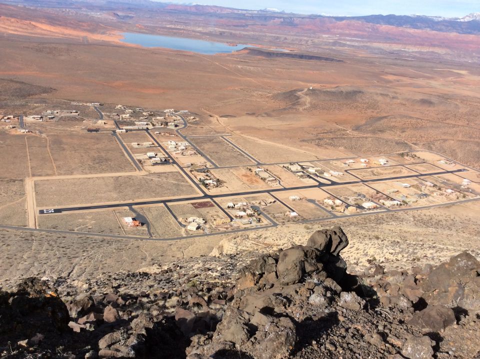 Aerial view of a desert residential development with a distant lake.