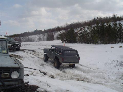1993 Ford Bronco - Multiple Ford Broncos and a truck navigate a snowy off-road course.